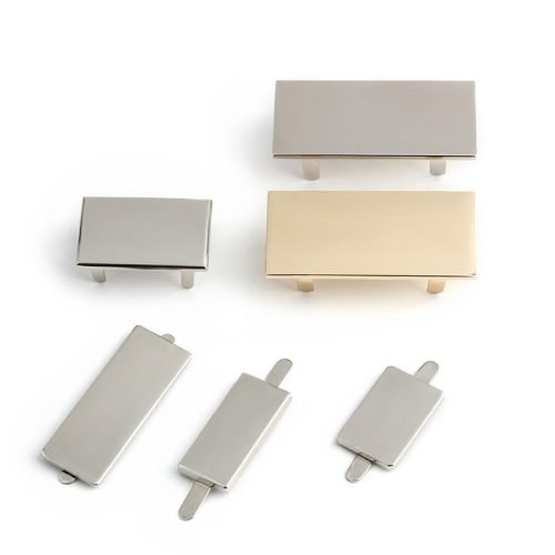 Blank metal logo plates in different sizes and finishes with prong attachments